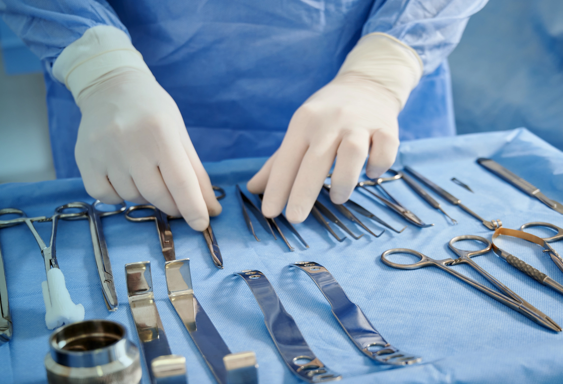 A sterile processing technician working with sterilized surgical instruments