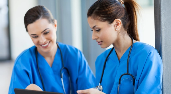 group of healthcare professionals sitting in a classroom during medical assistant training