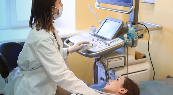 a cardiovascular technologist performing diagnostic tests on a patient after completing an employer-sponsored CVT program