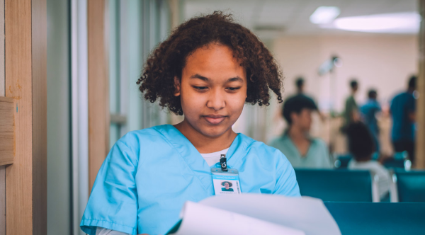 A healthcare professional reviews documents in a medical setting