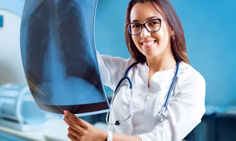 A healthcare professional holding an X-Ray image result