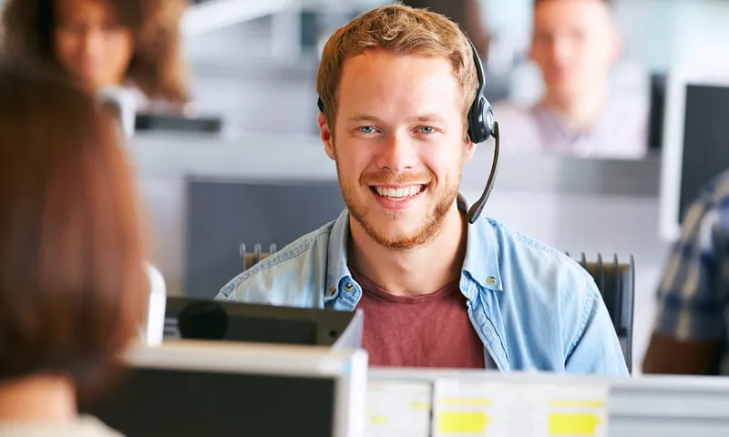 A man wearing a headset smiling