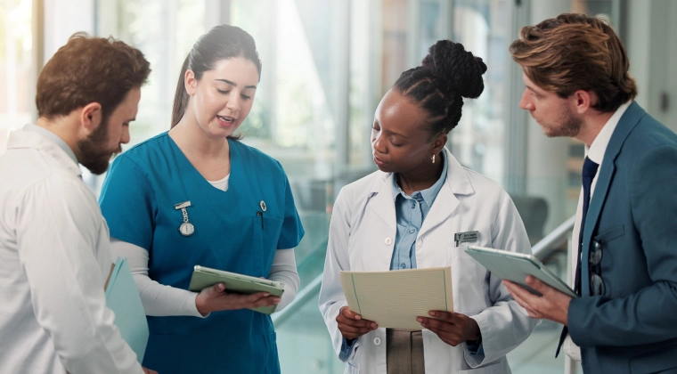 healthcare professionals review notes together