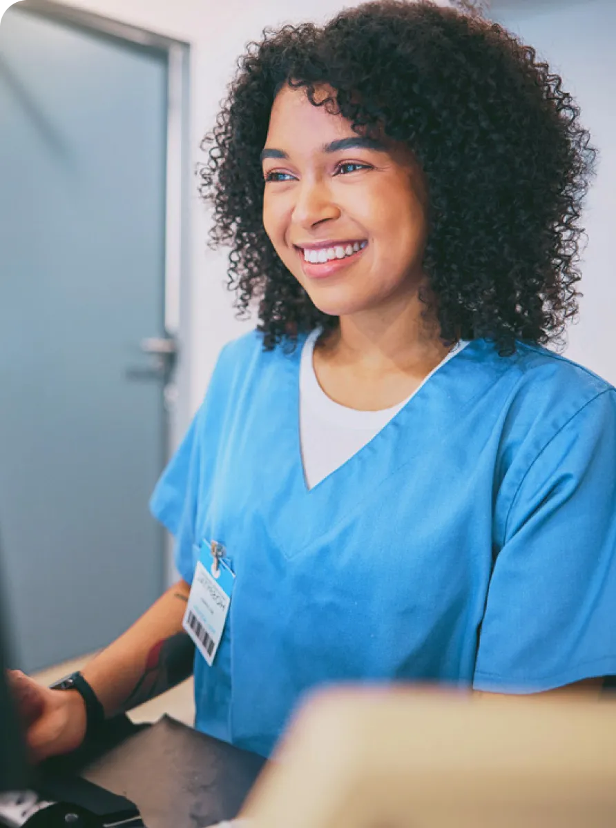 A woman in scrubs smiling